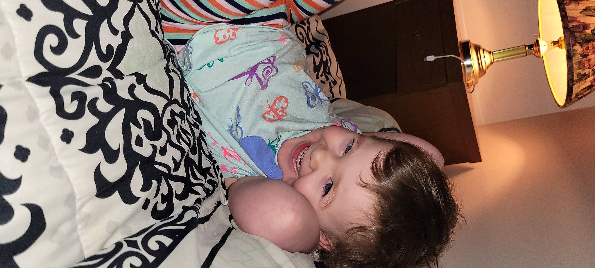 Kali is registered to the contest to win money with this photo: baby, baby_toddler_clothing, cheek, child, comfort, eyelash, fun, hairstyle, happy, human, joy, mammal, mouth, nose, pattern, person, product, room, skin, smile