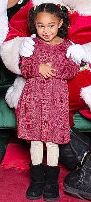 Noemí is registered to the contest to win money with this photo: child, christmas, costume, dress, fictional_character, fur, holiday, joy, magenta, outerwear, pattern, person, pink, santa_claus, toddler, wool