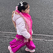 Mannat joined the competition — help win amazing prizes! child, girl, walking, pink_clothing, white_jacket, hair_bow, scarf, asphalt, street, side_view, sneakers, outdoor, traditional_clothing, winter_wear, young_child, person, fashion, colorful, cute, motion