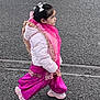 child, girl, walking, pink_clothing, white_jacket, hair_bow, scarf, asphalt, street, side_view, sneakers, outdoor, traditional_clothing, winter_wear, young_child, person, fashion, colorful, cute, motion