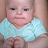 Emilia joined the competition — help win amazing prizes! baby, infant, person, face, arms, legs, onesie, skin, indoor, closeup, chubby, expression, hands, fists, cute, child, young, human, portrait, babywearing