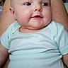 baby, child, infant, onesie, smiling, face, legs, person, indoor, furniture, home, skin, head, cute, happy, comfort, chubby, relaxed, sitting, closeup