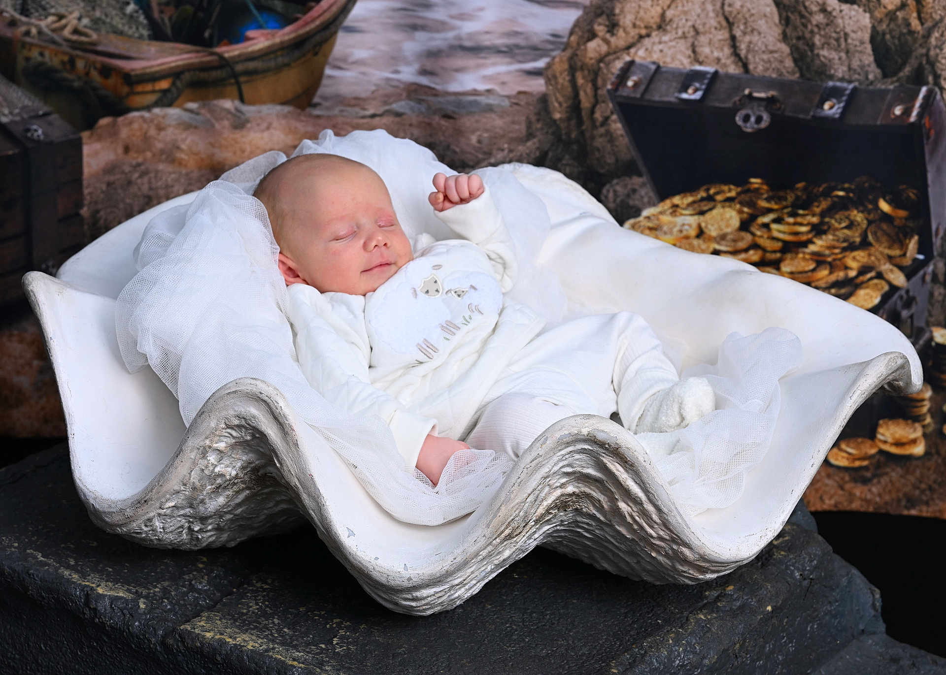 Theo is registered to the contest to win money with this photo: baby, sleeping, infant, clam_shell, treasure_chest, gold_coins, white_clothing, cute, peaceful, soft_fabric, decor, props, portrait, newborn, resting, indoors, creative_setup, baby_pose, artistic, fantasy_theme
