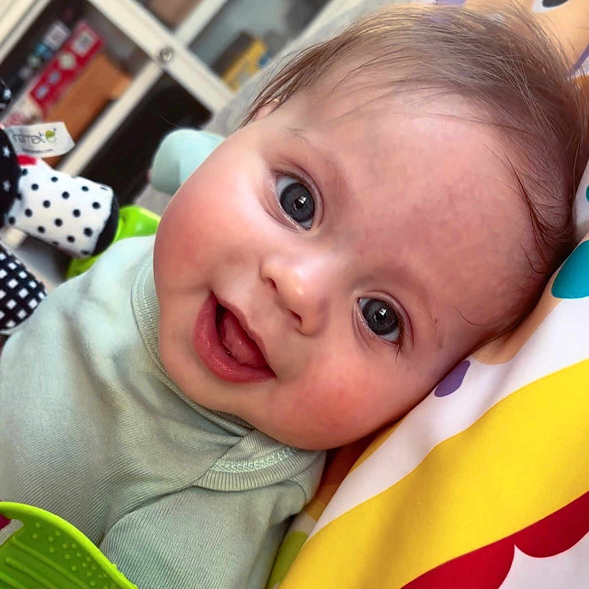 Cole is registered to the contest to win money with this photo: baby, blanket, bodypart, couch, cushion, face, furniture, happy, head, homedecor, laughing, mouth, newborn, pattern, person, photography, portrait, quilt, reading, smile