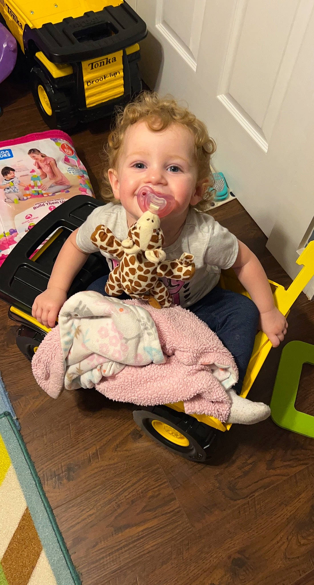 Bethany joined the competition — help win amazing prizes! baby, baby_playing_with_toys, baby_products, baby_toddler_clothing, baby_toys, cheek, child, face, flooring, fun, hardwood, lap, person, play, room, sitting, smile, sock, toddler, wood