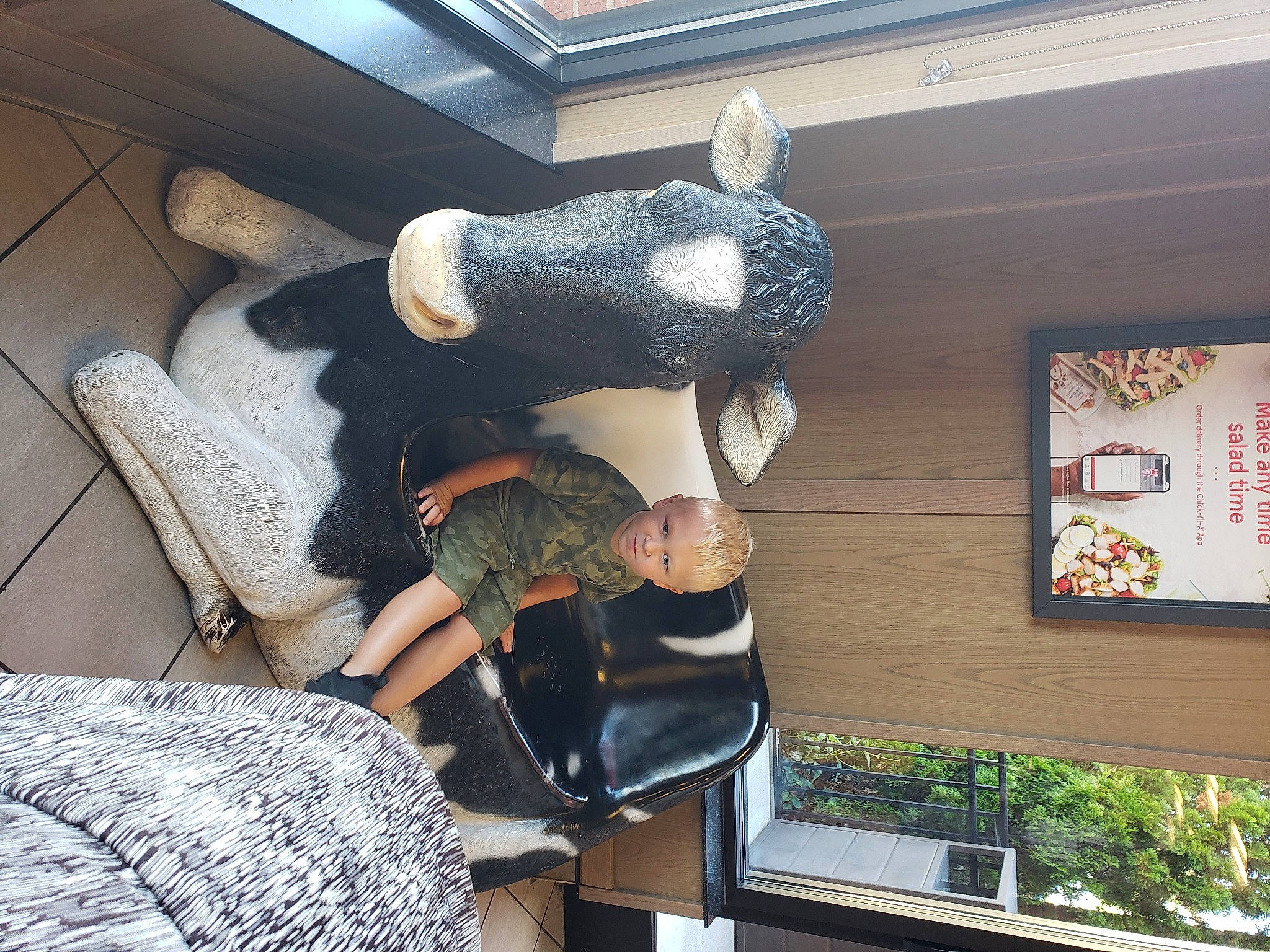 Heath is registered to the contest to win money with this photo: comfort, fur, hat, human_leg, leisure, luggage_and_bags, pattern, person, room, sitting, stuffed_toy, thigh, toy, wool