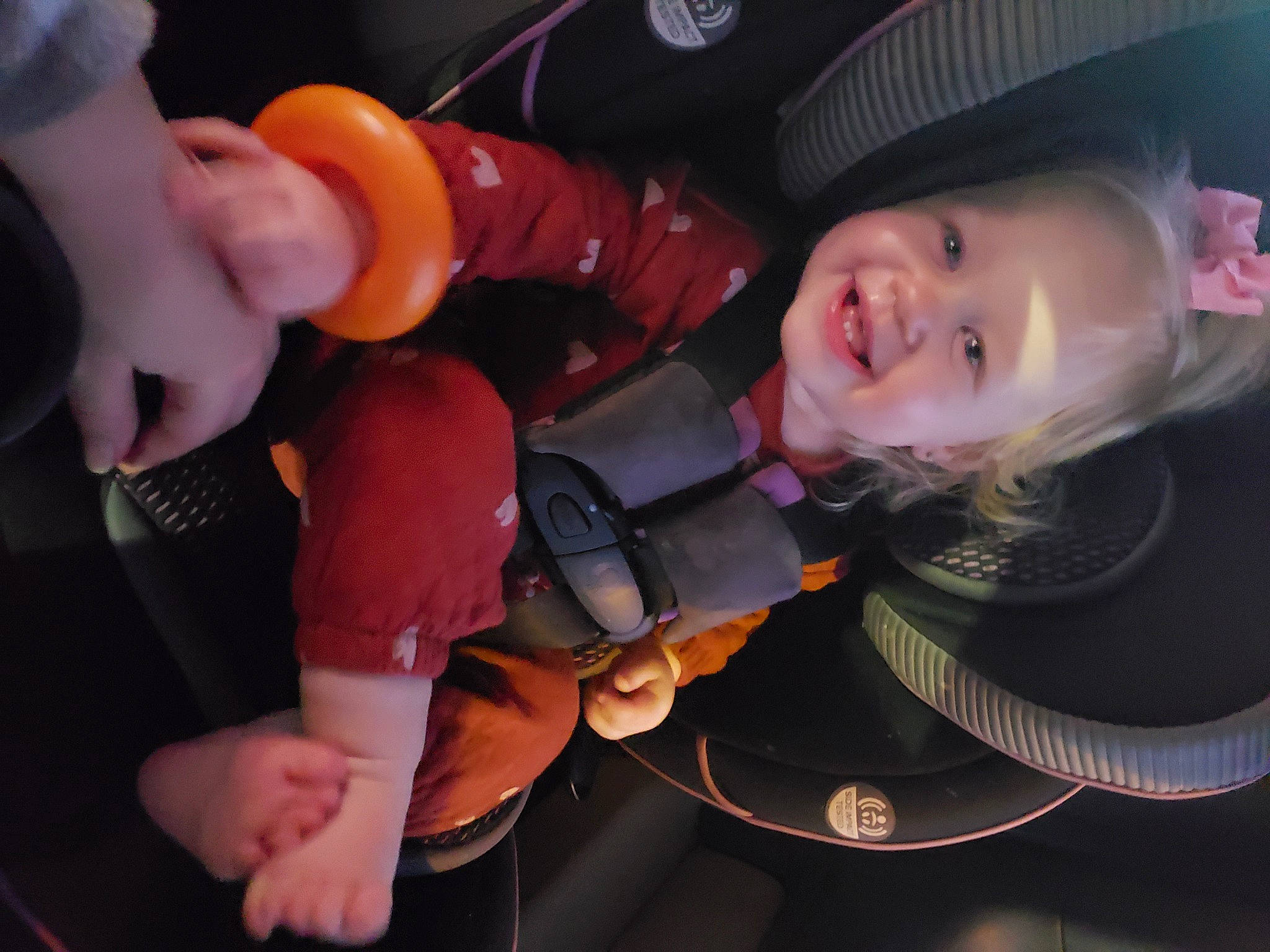 Kynsleigh is registered to the contest to win money with this photo: audio_equipment, auto_part, automotive_lighting, baby_products, car_seat, carmine, child, costume, event, fashion_accessory, fun, headgear, joy, lap, mouth, person, personal_protective_equipment, sun_hat, thumb, toddler