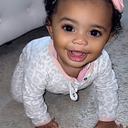 Journee is registered to the contest to win money with this photo: baby, child, crawling, smiling, happy, portrait, face, bow, headband, curly_hair, eyes, open_mouth, onesie, pink, indoor, carpet, toy, playroom, close_up, sitting