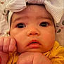 Amelia joined the competition — help win amazing prizes! baby, infant, face, headband, bow, yellow_clothing, closeup, cute, hands, fists, skin, expression, portrait, child, newborn, eyes, soft_light, indoors, texture, adorable