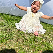 Rahmirah joined the competition — help win amazing prizes! baby, child, grass, outdoor, dress, headband, white, lace, smiling, happy, sitting, sunlight, cute, person, infant, nature, playful, portrait, barefoot, summer
