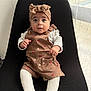baby, infant, child, sitting, headband, romper, white_tights, chair, black_chair, curious_eyes, indoors, natural_light, window, sheer_curtains, cute, clothing, portrait, small_hands, expression, comfortable