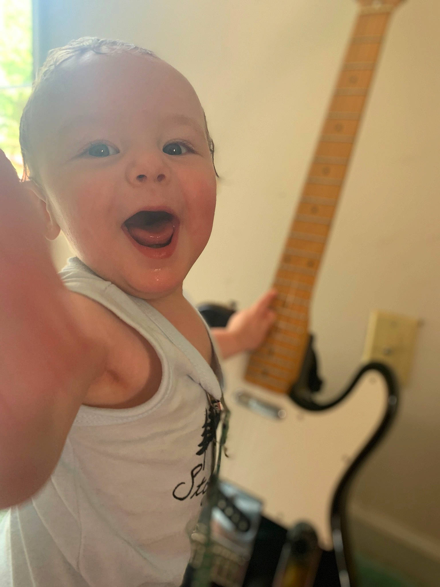 River Ray joined the competition — help win amazing prizes! baby, chin, finger, gesture, guitar, guitar_accessory, guitarist, happy, head, human_body, iris, mouth, musical_instrument, musician, person, plucked_string_instruments, skin, smile, string_instrument, string_instrument_accessory