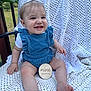 baby, infant, smile, blue_romper, white_bow, crocheted_blanket, outdoor, grass, wooden_sign, happy, child, cute, milestone, portrait, sitting, person, toes, hand, face, young_child