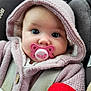 baby, pacifier, hoodie, knitted_clothing, car_seat, child, face, wide_eyes, cute, infant, pink, warm_clothing, seatbelt, portrait, close_up, soft_texture, indoor, baby_accessory, sitting, cozy