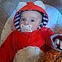 Grace joined the competition — help win amazing prizes! baby, pacifier, hoodie, red_clothing, fuzzy_toy, cushioned_chair, blue_eyes, striped_hood_lining, indoor, cute, child, infant, soft_texture, star_pattern, hand, portrait, closeup, cozy, person, young_child