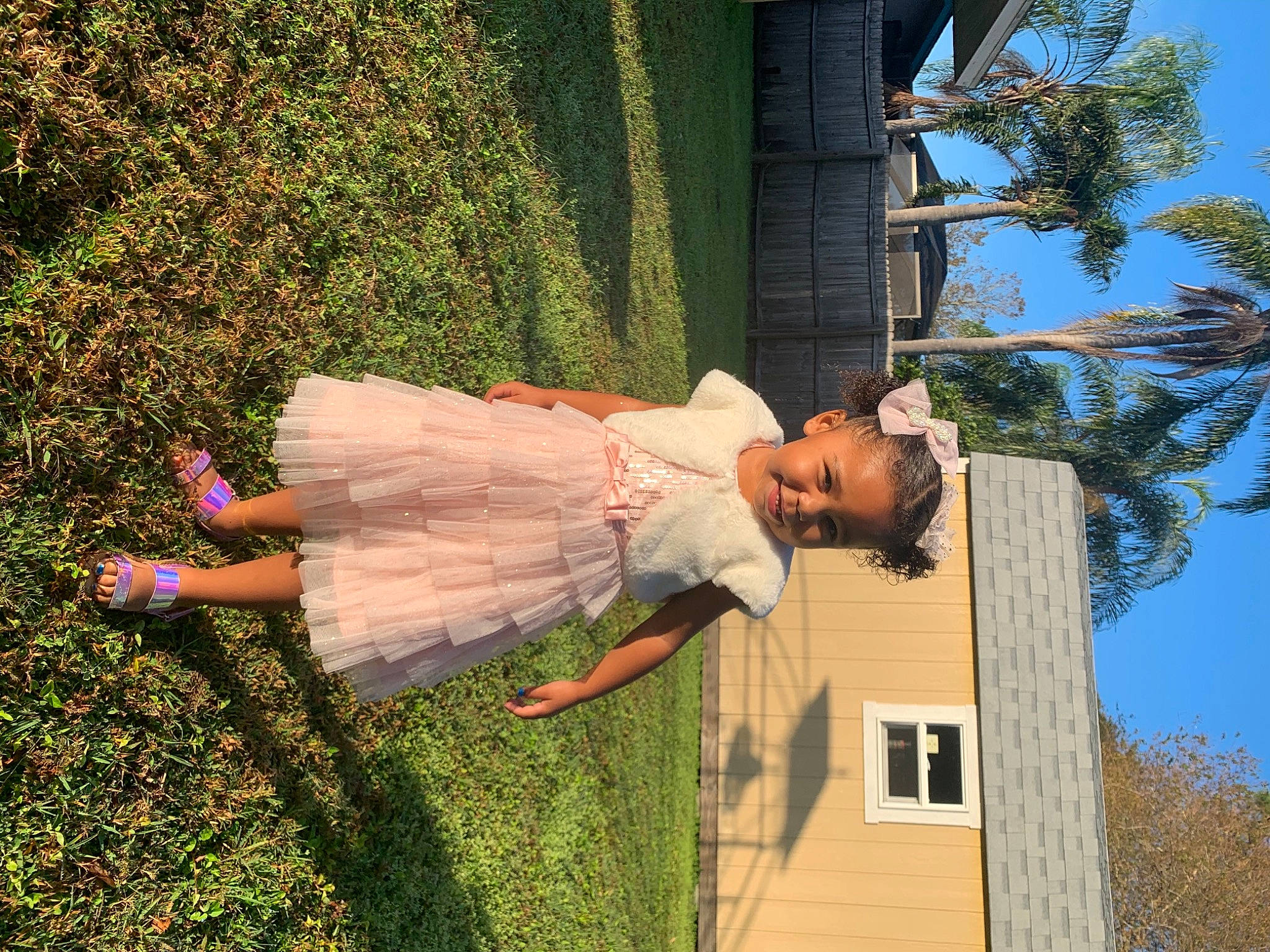 Aiyanna is registered to the contest to win money with this photo: fun, grass, happy, house, human_leg, joy, leisure, people_in_nature, person, plant, sandal, shrub, sky, thigh, tree, window, wood