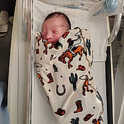 Jackson joined the competition — help win amazing prizes! baby, baby_bottle, bassinet, bed, blanket, child, cowboy_theme, cute, face, hospital, hospital_room, infant, newborn, peaceful, person, resting, sleeping, soft, swaddled, white