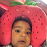 Layal is registered to the contest to win money with this photo: baby, child, closeup, clothing, curious, cute, expression, face, head_support, indoor, infant, neck_pillow, plush, portrait, seat, soft_toy, stars, strawberry, white, wide_eyes