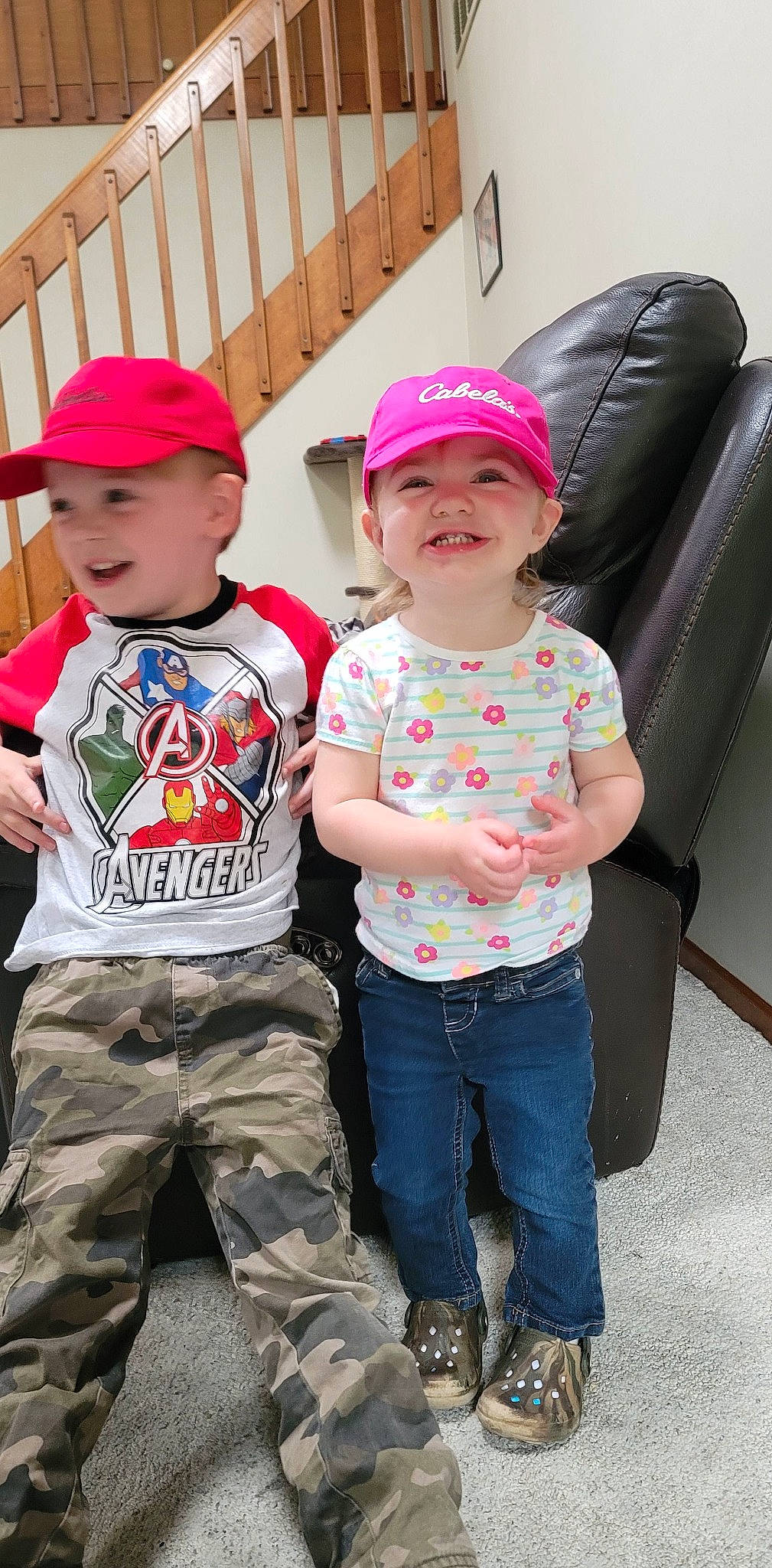 Riley is registered to the contest to win money with this photo: baseball_cap, cap, child, clothing, cool, denim, fun, gesture, happy, headwear, joy, magenta, person, photograph, pink, red, sleeve, sneakers, standing, style