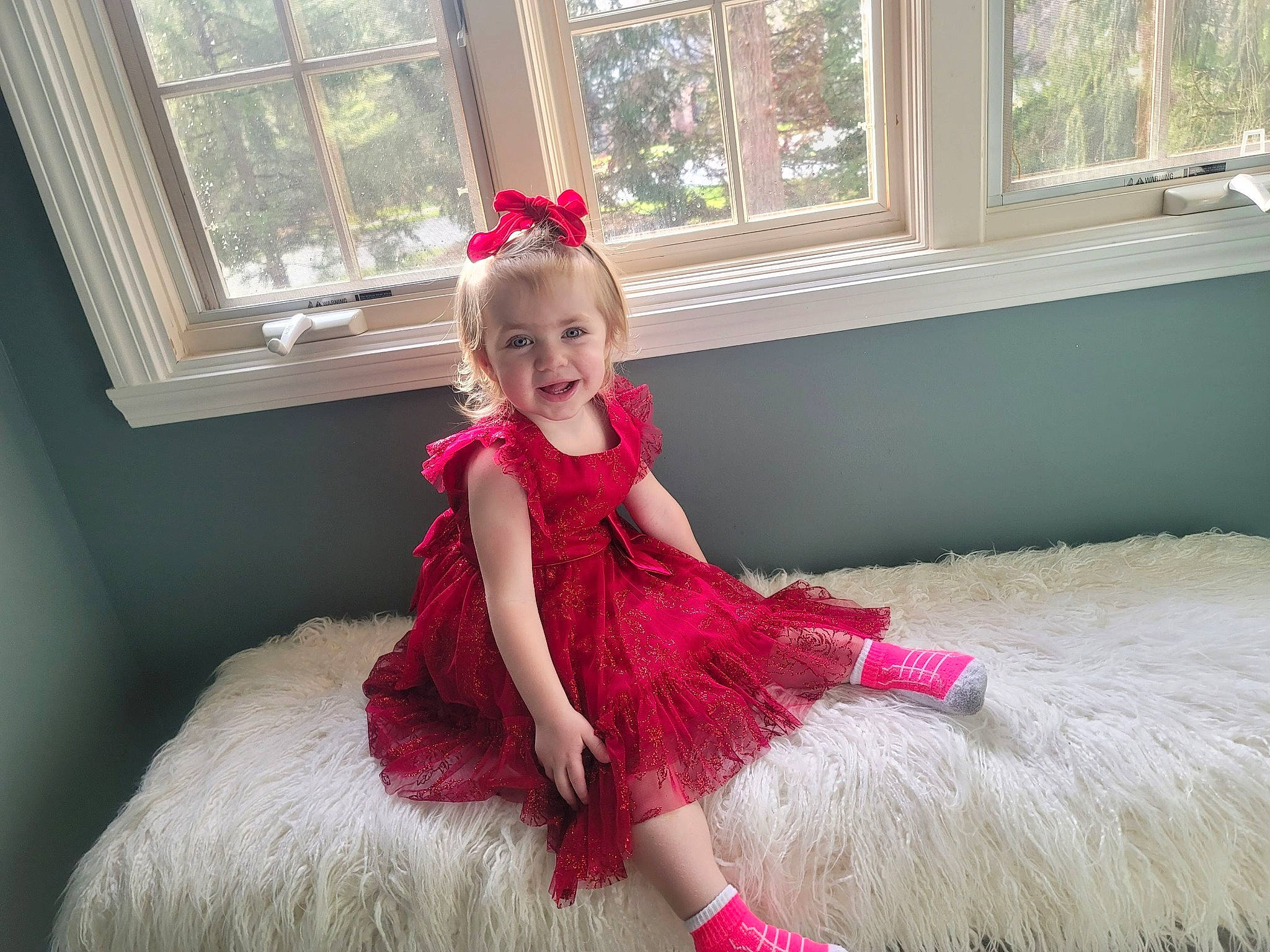 Riley is registered to the contest to win money with this photo: baby_toddler_clothing, beauty, couch, day_dress, dress, embellishment, face, formal_wear, gown, happy, headpiece, joy, magenta, person, petal, picture_frame, pink, smile, textile, toddler
