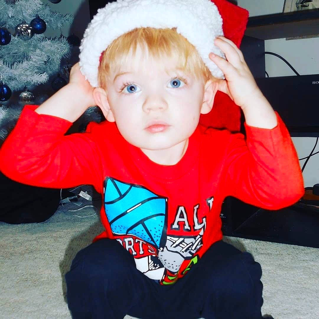 Gabe is registered to the contest to win money with this photo: baby, cheek, child, christmas, christmas_eve, cool, costume, ear, fictional_character, happy, head, headgear, holiday, outerwear, person, santa_claus, sleeve, smile, t_shirt, toddler