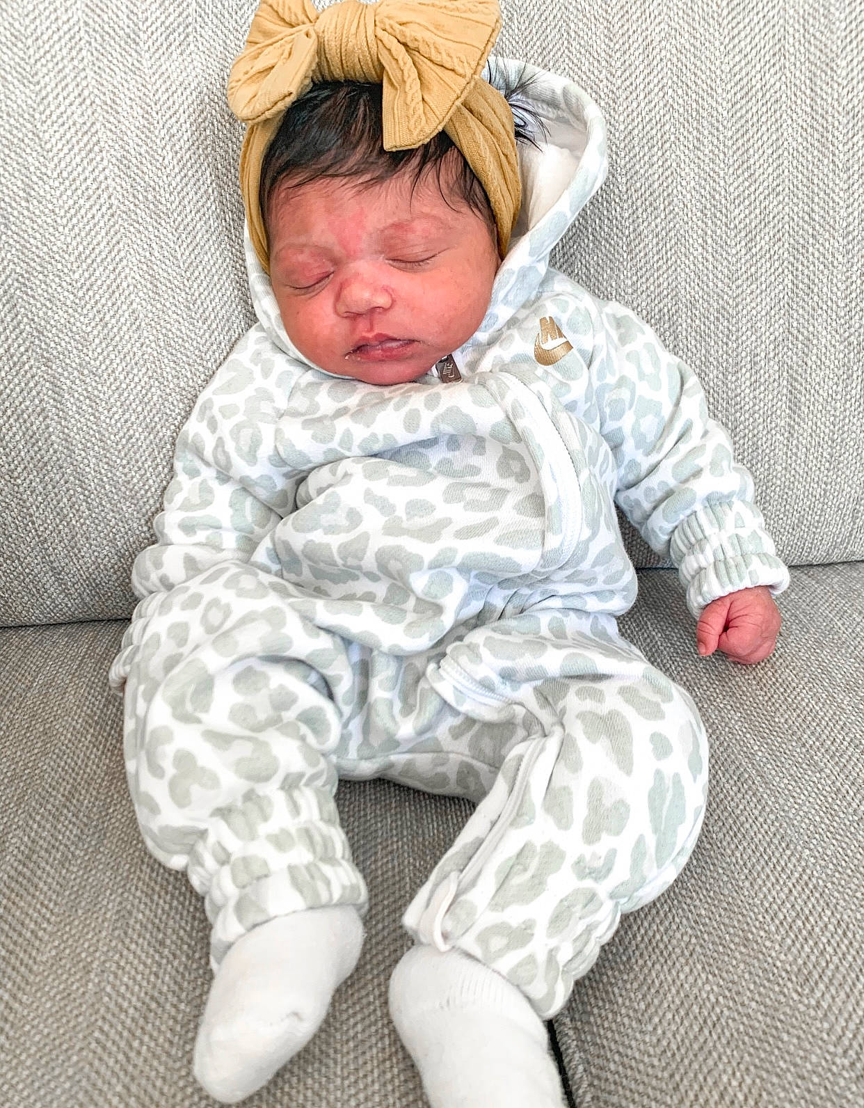 Saige is registered to the contest to win money with this photo: baby, baby_toddler_clothing, cheek, child, chin, collar, comfort, eye, face, flooring, foot, head, human_body, knee, mouth, person, skin, sleeve, textile, thigh