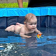 Montgomerie is registered to the contest to win money with this photo: adult, baby, bathing, clothing, face, female, head, leisureactivities, person, photography, pool, portrait, sport, summer, swimming, swimmingpool, vest, water, watersports, woman