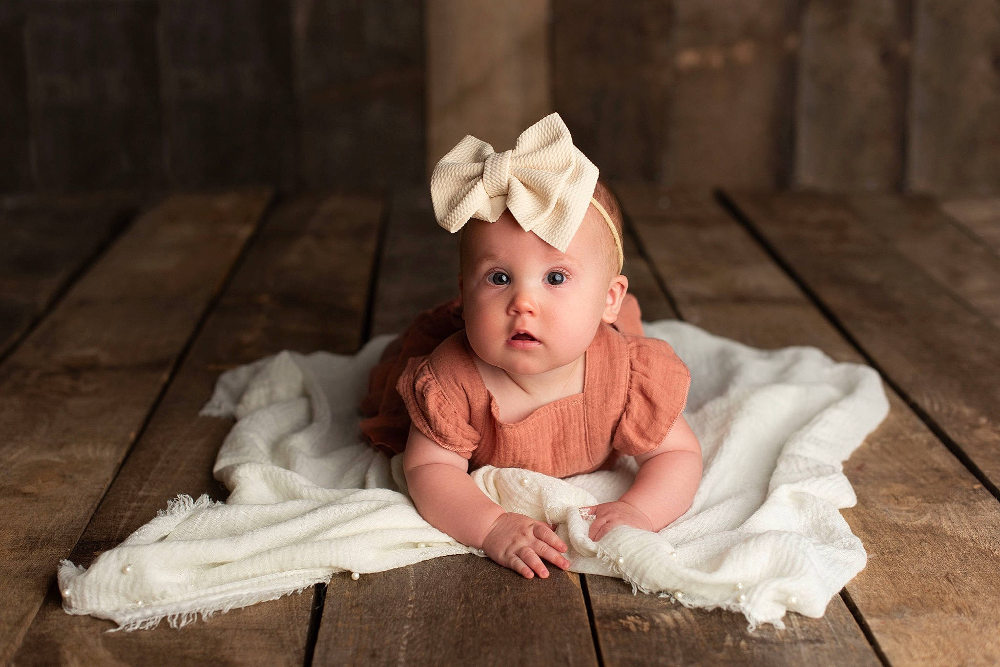Kambrie is registered to the contest to win money with this photo: baby, baby_toddler_clothing, cheek, child, dress, embellishment, eye, fashion_accessory, flash_photography, flooring, grass, happy, headgear, headpiece, headwear, jewellery, person, sitting, skin, sleeve