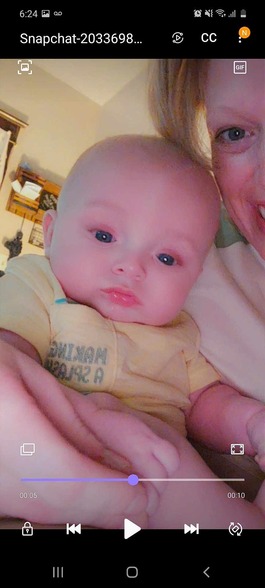 Gunnar is registered to the contest to win money with this photo: baby, infant, person, face, adult, smile, indoor, yellow_shirt, hand, closeup, blue_eyes, skin, head, expression, holding, family, portrait, child, caucasian, room