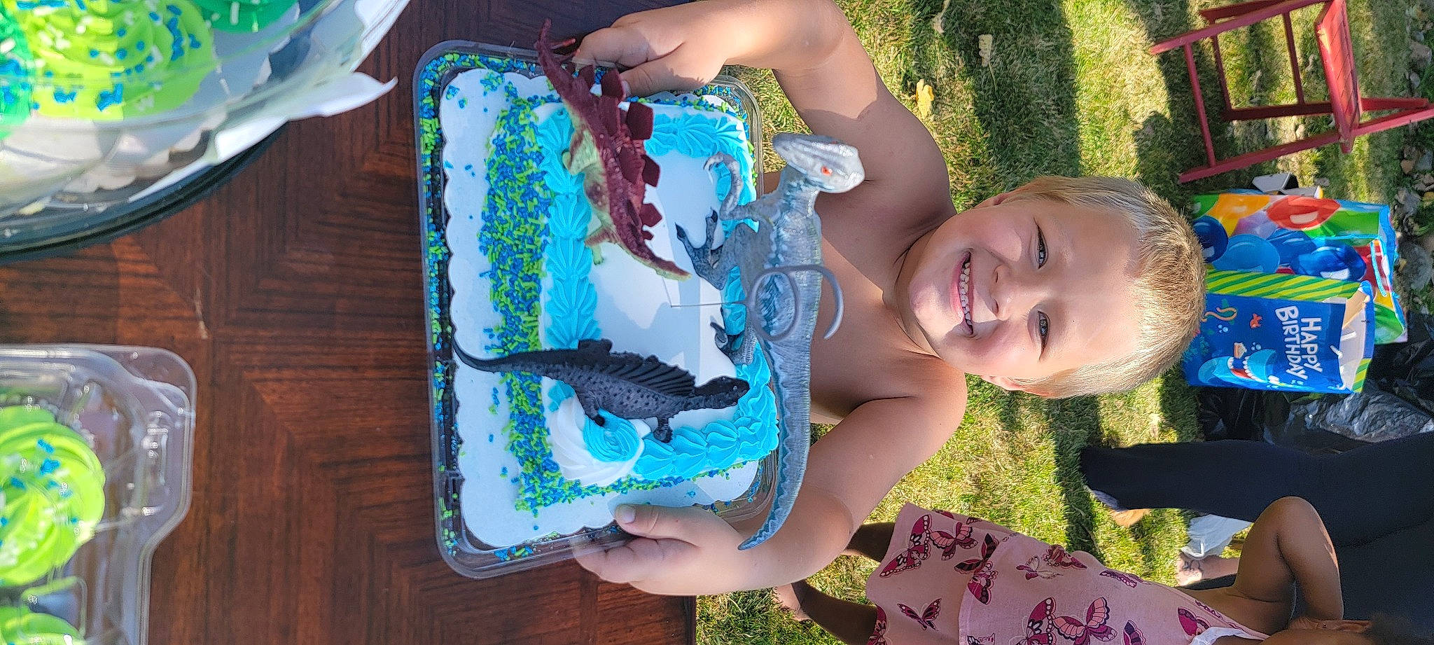 Eric is registered to the contest to win money with this photo: art, baby_toddler_clothing, blue, child, cool, electric_blue, finger, fun, grass, green, hand, happy, jewellery, joy, leisure, pattern, people_in_nature, person, smile, toddler