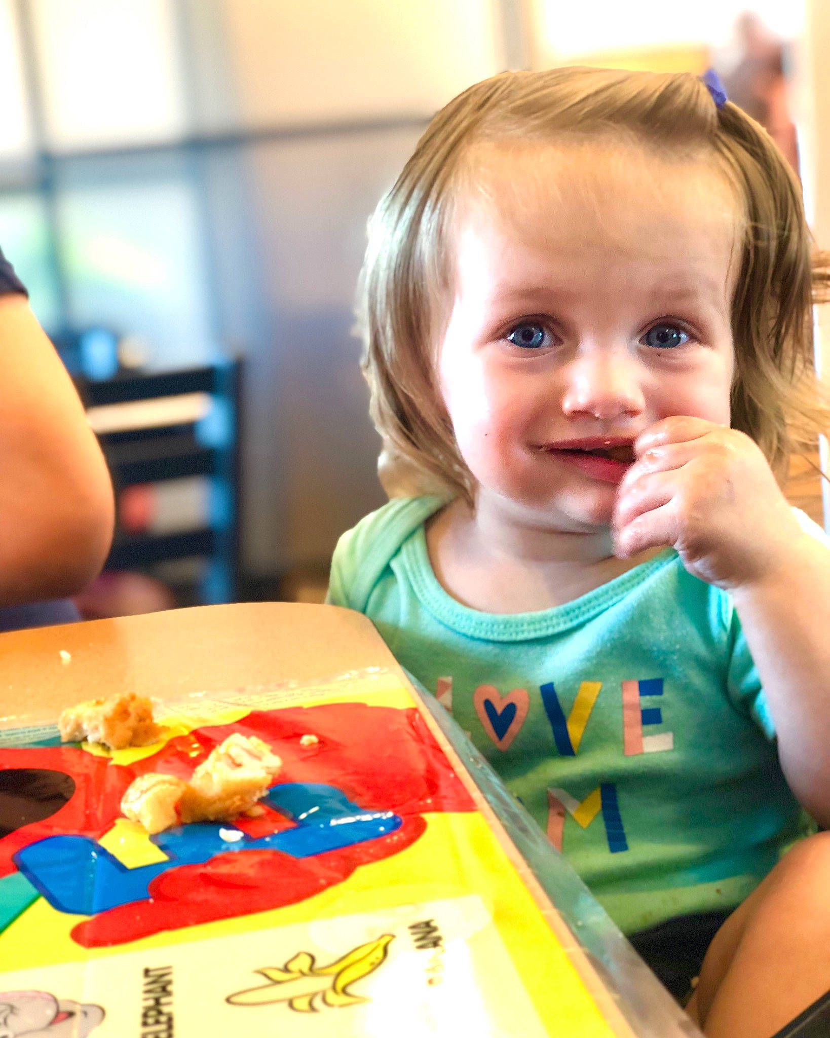 Scarlett is registered to the contest to win money with this photo: baby, baby_toddler_clothing, chair, child, comfort_food, event, fun, happy, indoor_games_and_sports, joy, junk_food, leisure, person, play, recreation, room, sitting, smile, sweetness, t_shirt