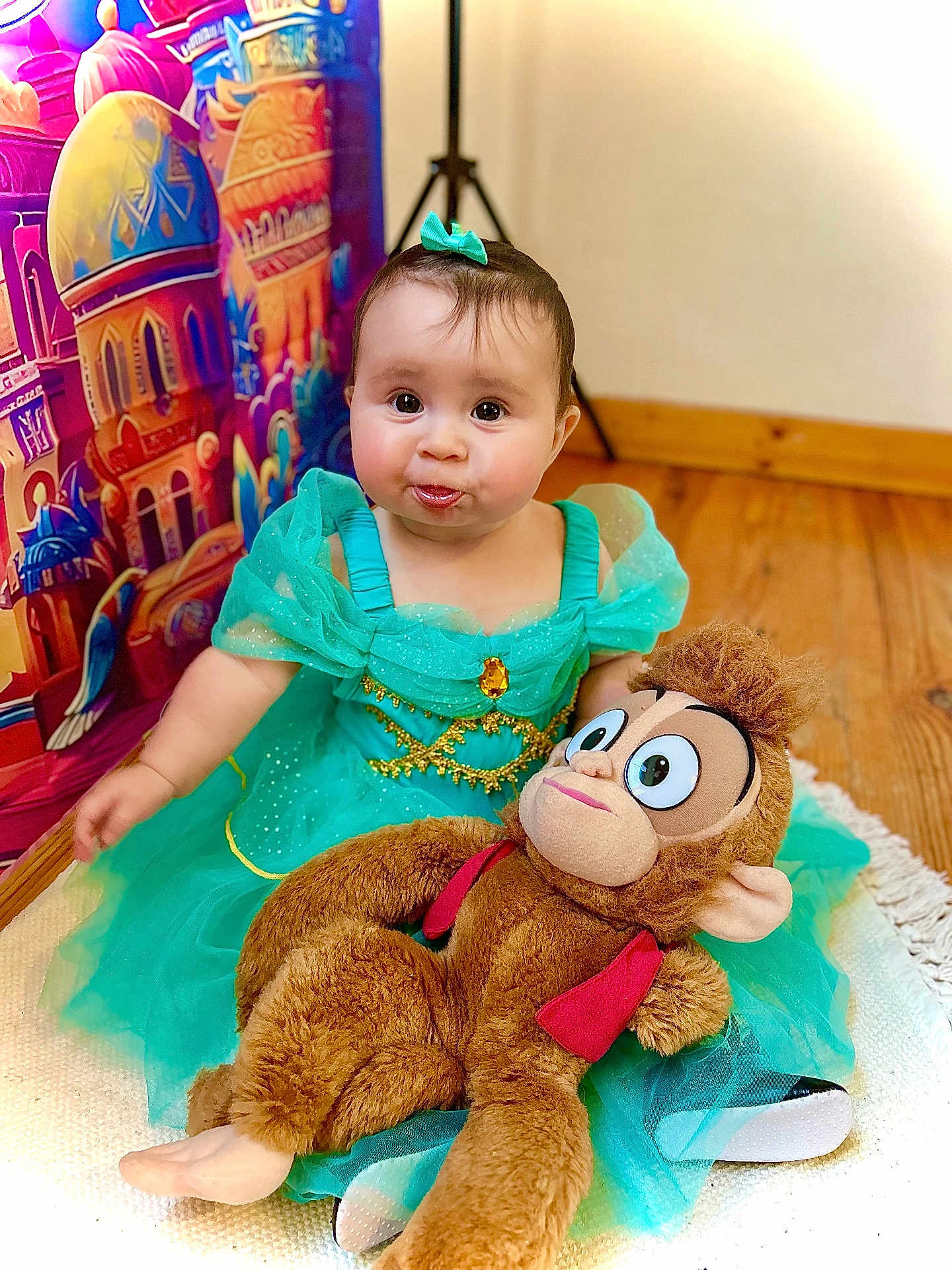 Maïley participe au concours pour gagner de l'argent avec cette photo : baby, child, dress, princess, toy, plush, monkey, indoor, floor, mat, colorful, background, castle, cute, smiling, sitting, person, portrait, happy, playful