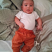 Jaxon joined the competition — help win amazing prizes! baby, bed, blanket, child, comfort, cute, expression, face, head, indoors, infant, lying_down, orange_pants, resting, skin, sleepwear, small_hands, socks, soft_texture, white_onesie