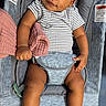 baby, blanket, car_seat, casual, child, cute, expression, fabric, footwear, head, indoors, infant, portrait, relaxed, seat_belt, skin, smiling, sneakers, striped_clothing, young_child