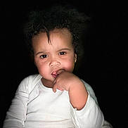 Kaliah joined the competition — help win amazing prizes! casual_clothing, child, curly_hair, cute, cute_expression, dark_background, earrings, expression, face, floral_pants, hand_on_mouth, indoor, person, portrait, sitting, skin_tone, thinking, toddler, white_shirt, young_child