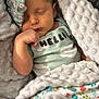 baby, sleeping, blanket, onesie, soft_texture, cozy, infant, child, wrapped, cute, peaceful, face, hand, pale_skin, indoors, resting, comfort, head, closed_eyes, toddler