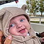 baby, child, hoodie, smile, blue_eyes, cute, outdoor, hand, person, face, clothing, button, tree, railing, happy, portrait, infant, warm_clothing, cozy, expression