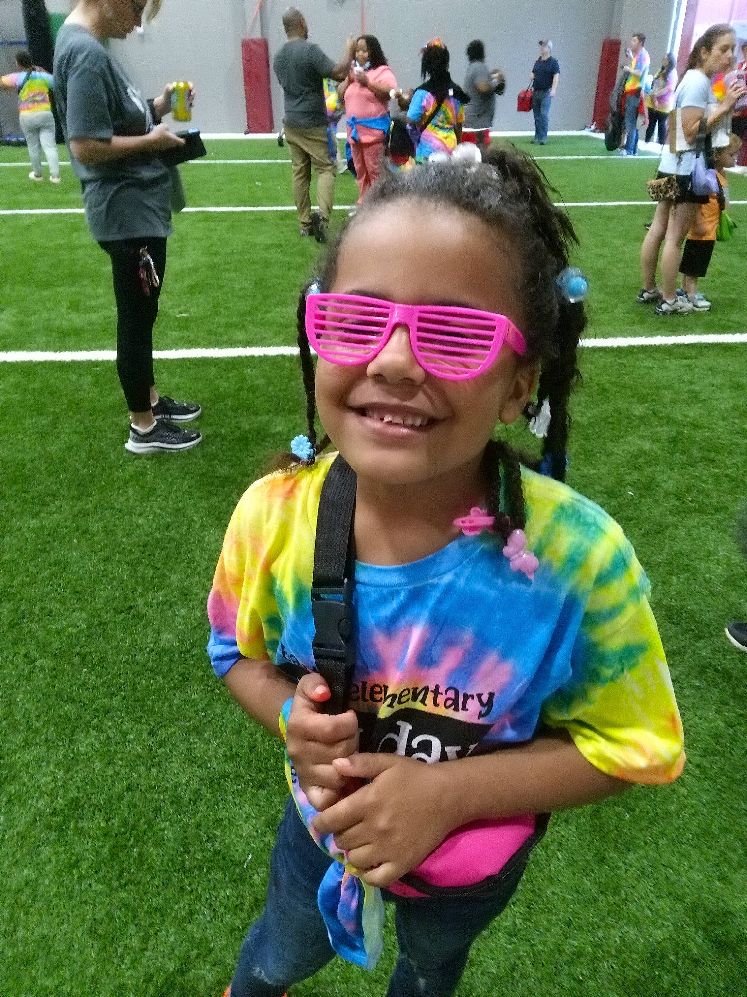 Isabella is registered to the contest to win money with this photo: chair, clothing, competition_event, event, eyewear, fun, games, grass, green, happy, joy, leisure, person, player, recreation, shorts, smile, sports, t_shirt, team