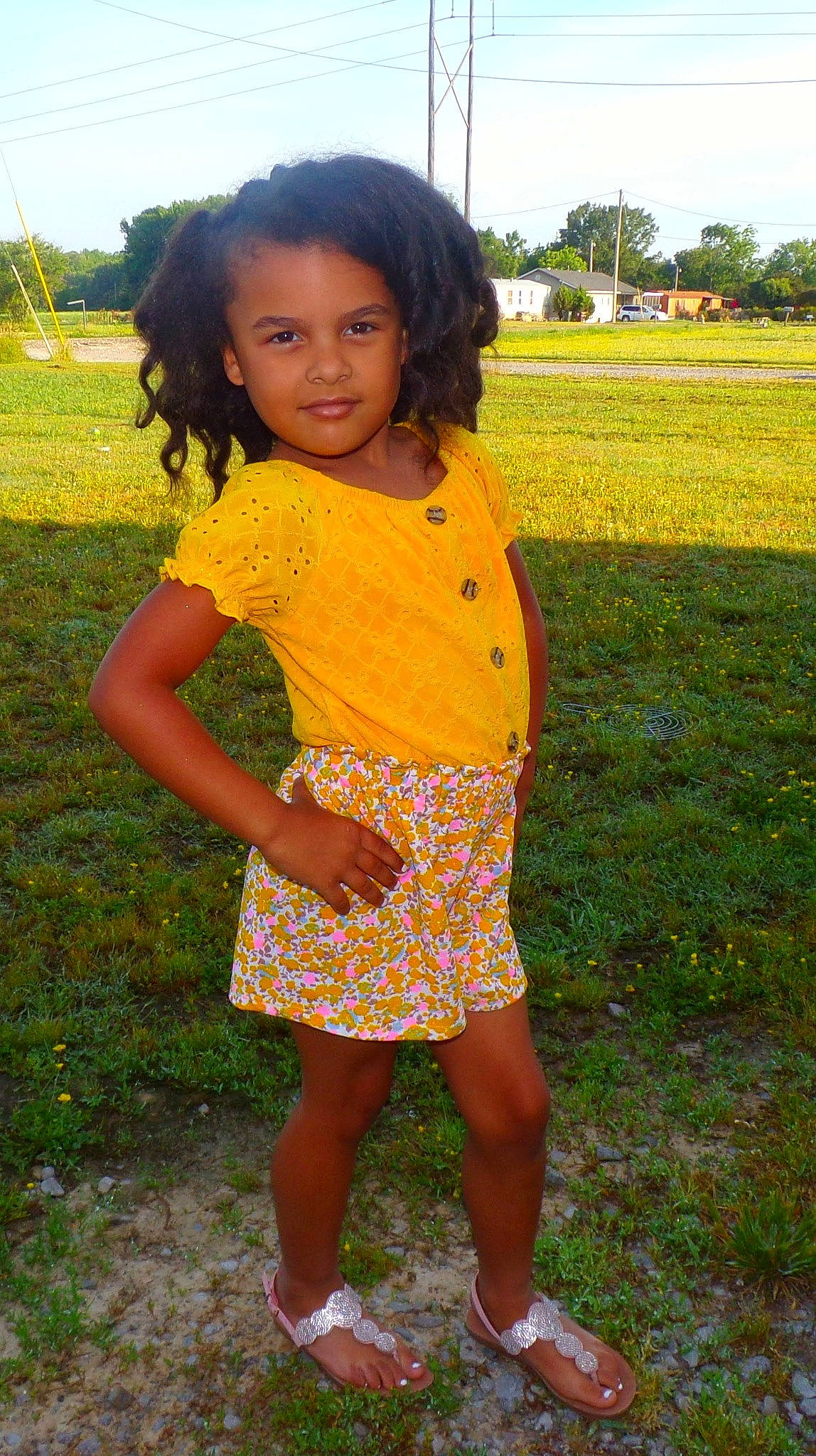 Anastasia is registered to the contest to win money with this photo: baby_toddler_clothing, child, day_dress, field, fun, grass, grassland, hairstyle, happy, human_leg, joy, leisure, pattern, people_in_nature, person, plant, sky, sleeve, thigh, toddler