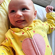 Kinsley joined the competition — help win amazing prizes! baby, bodypart, clothing, coat, cushion, face, finger, furniture, hand, happy, head, homedecor, jacket, laughing, newborn, person, photography, portrait, quilt, smile