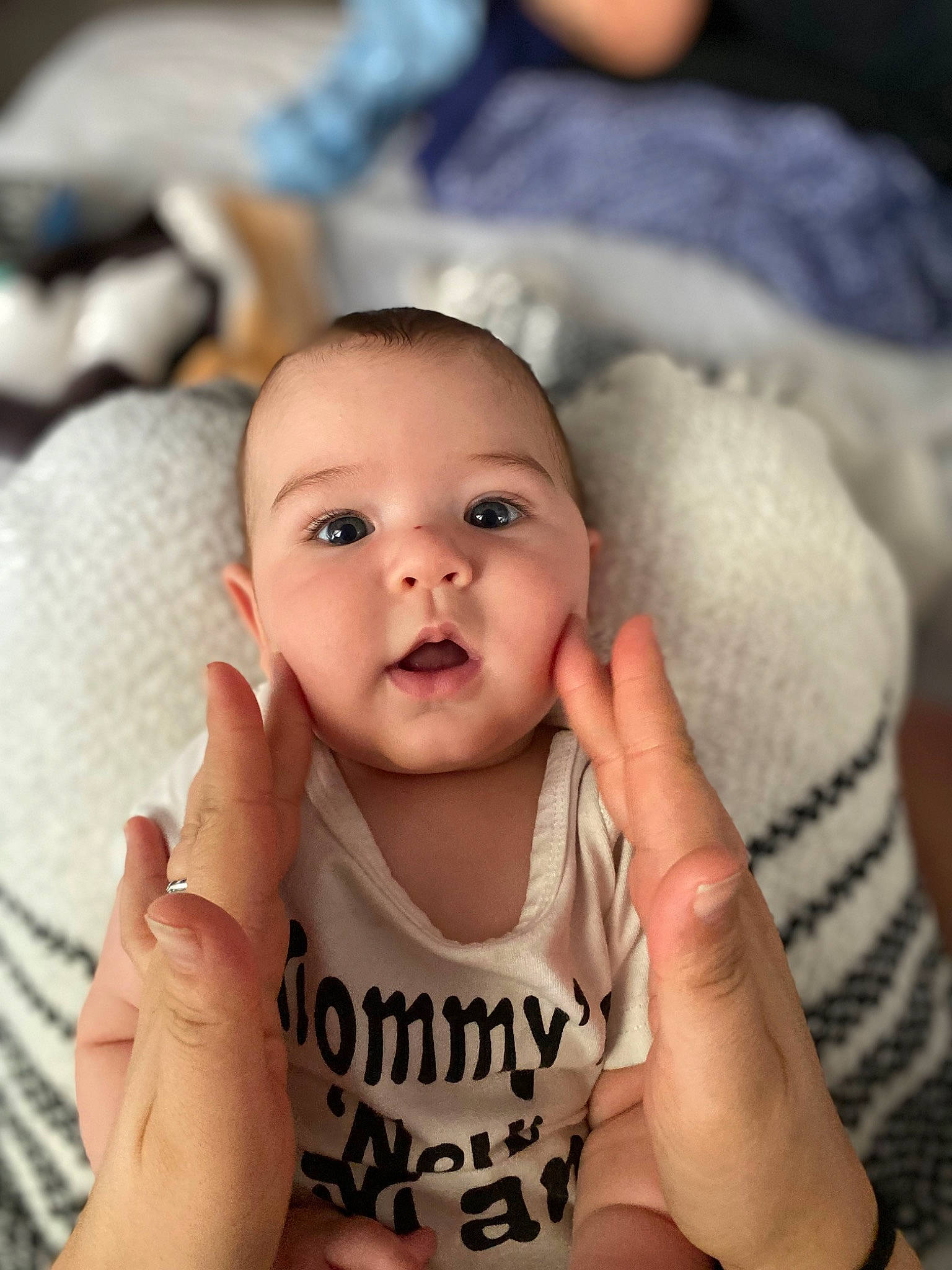 Jimmy is registered to the contest to win money with this photo: arm, baby, baby_toddler_clothing, cheek, comfort, eye, eyelash, face, finger, gesture, hand, happy, head, iris, lip, mouth, nose, person, skin, thumb