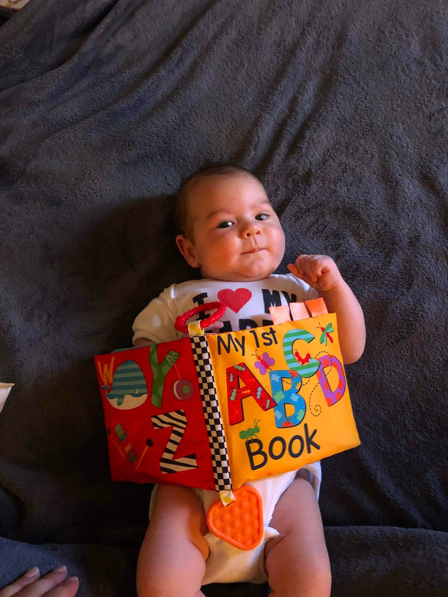 Jimmy is registered to the contest to win money with this photo: baby, baby_products, baby_toddler_clothing, child, comfort, eye, finger, fun, happy, nail, orange, person, sitting, skin, sleeve, smile, t_shirt, thigh, thumb, toddler