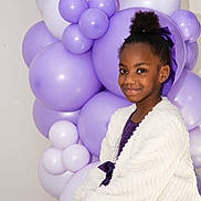 Luna Lopes a rejoint le concours — aidez-le/la à gagner de superbes lots ! child, girl, balloons, purple, dress, smile, portrait, party, celebration, bow, hair_bun, jacket, white_jacket, decor, indoor, cheerful, looking_at_camera, sitting, studio_lighting, background