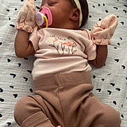 Emorie joined the competition — help win amazing prizes! baby, sleeping, pacifier, mittens, headband, flower, pink, brown, clothing, blanket, pattern, infant, cute, cozy, newborn, socks, striped, laying_down, peaceful, soft
