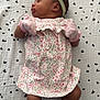 Emorie is registered to the contest to win money with this photo: baby, newborn, sleeping, floral_dress, mittens, headband, blanket, patterned_blanket, white_socks, infant, cute, peaceful, portrait, laying_down, indoors, child, soft_lighting, small, adorable, resting