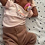 Emorie is registered to the contest to win money with this photo: baby, sleeping, pacifier, headband, flower, pink_clothing, brown_pants, striped_socks, blanket, hearts_pattern, infant, cute, resting, soft_fabric, newborn, toddler, child, indoors, portrait, cozy