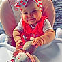 baby, child, clothing, cute, face, furniture, hands, happy, headband, high_chair, indoor, infant, pink, plush_bunny, polka_dot, red, smile, toy, white, window