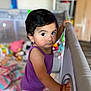 Arliss Selah is registered to the contest to win money with this photo: baby, baby_girl, blanket, candid, child, close_up, colorful, curious, expression, face, hand, home, indoor, person, playpen, portrait, purple_clothing, toddler, toys, young_child