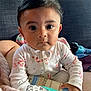 Arliss Selah is registered to the contest to win money with this photo: baby, child, onesie, floral, eczema_cream, therapy, bottle, blanket, couch, furniture, indoors, person, portrait, cute, infant, clothing, hand, face, expression, soft