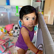 Arliss Selah joined the competition — help win amazing prizes! baby, blanket, bracelet, child, colorful, curious, expression, face, floor_mat, home, indoor, person, play_area, playpen, purple_onesie, soft_toys, standing, toddler, toys, young_child
